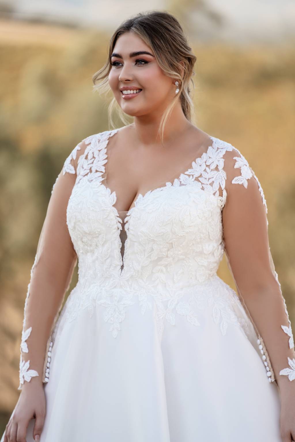 A downright glowing plus-sized bride who chose not to wear a veil for her wedding.